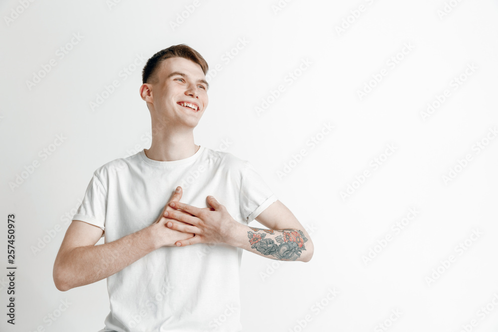 Happy business man standing, smiling isolated on gray studio background. Beautiful male half-length portrait. Young satisfy man. Human emotions, facial expression concept. Happy business man standing, smiling isolated on gray studio background. Beautiful male half-length portrait. Young satisfy man. Human emotions, facial expression concept.