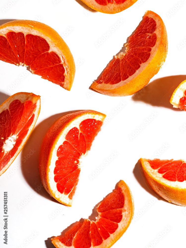 Slices of juicy grapefruit on a white background. Slices of juicy grapefruit on a white background.