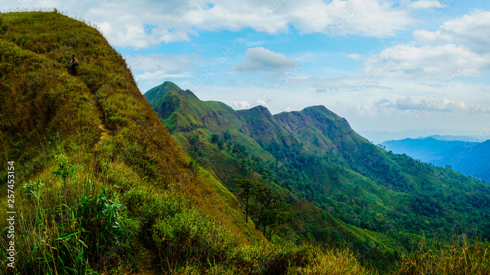 Mountain peak range landscape. Green mountain range view. Mountain peak blue sky white clouds panorama Mountain peak range landscape. Green mountain range view. Mountain peak blue sky white clouds panorama