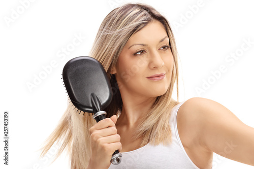 Woman brushing her hair with a hair brush