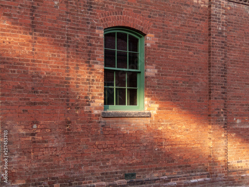 old window in red brick wall