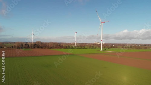 Aerial view of three windmills on a sunny winter day
