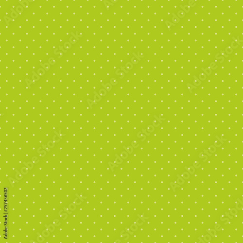 Seamless pattern for textiles and wallpaper - small yellow polka dots on a green background.