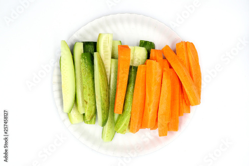 Fresh cucumber and carrots slice isolated on white background