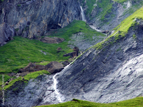 Nameless waterfalls under the Alpine peaks Glarner Vorab and Bünder Vorab in the valley of Im Loch - Canton of Glarus, Switzerland photo