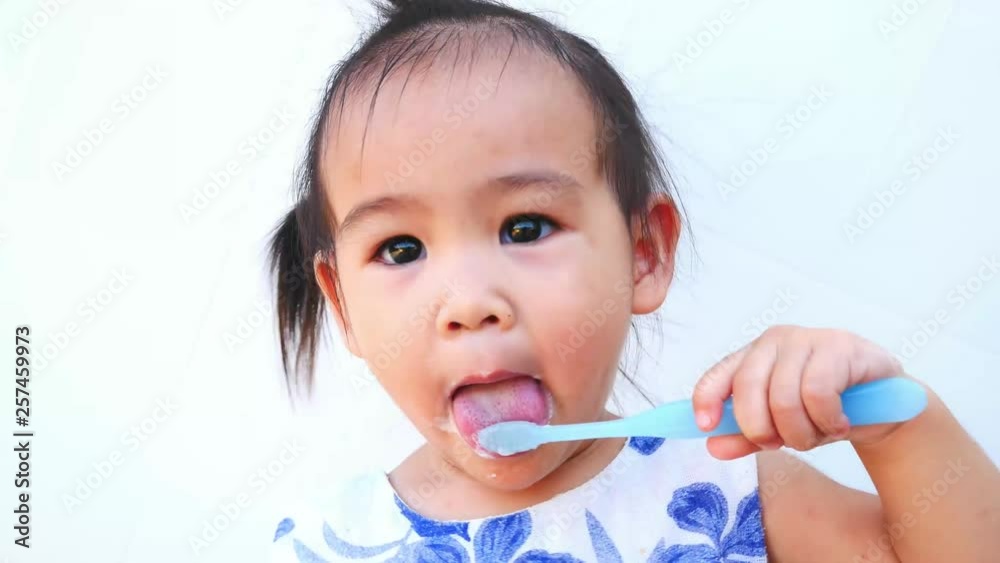 Portrait of Asian little child brushing teeth happily isolated on white background. Portrait of Asian little child brushing teeth happily isolated on white background.