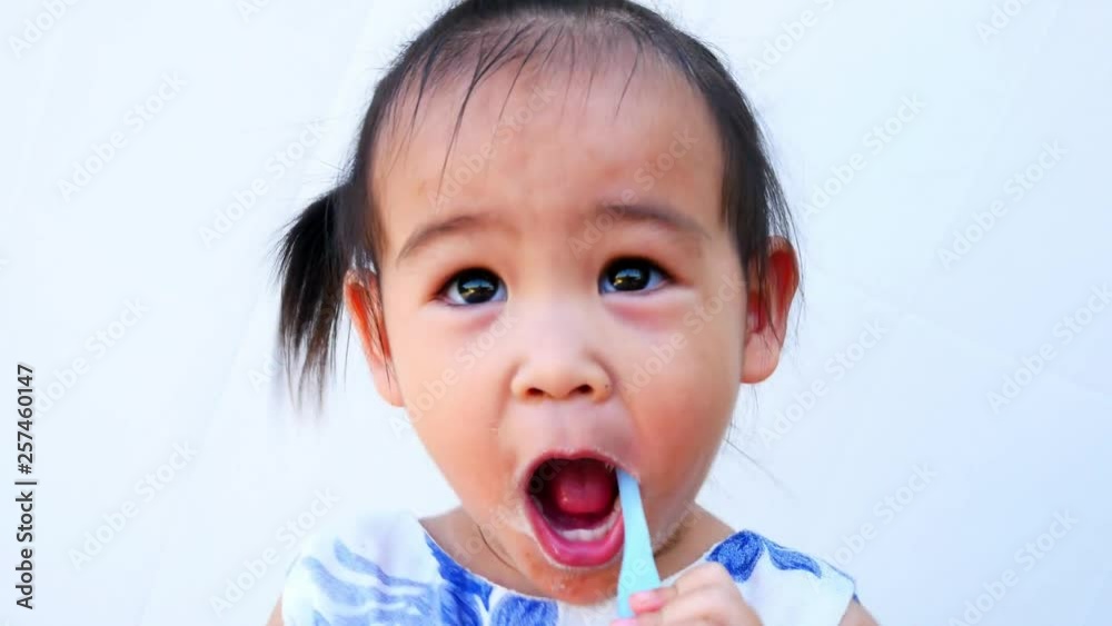 Portrait of Asian little child brushing teeth happily isolated on white background. Portrait of Asian little child brushing teeth happily isolated on white background.