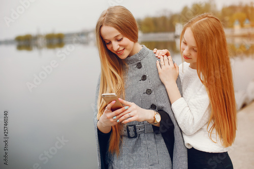 two pretty sisters in a park