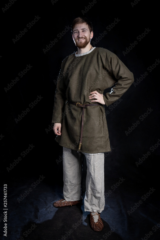 young bearded man in casual wear of a viking era smiling young bearded man in casual wear of a viking era smiling