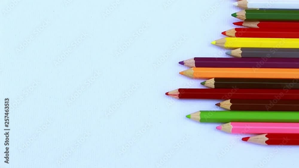 Close up of colorful pencils are rolling on white paper background. with copy spaces. Close up of colorful pencils are rolling on white paper background. with copy spaces.
