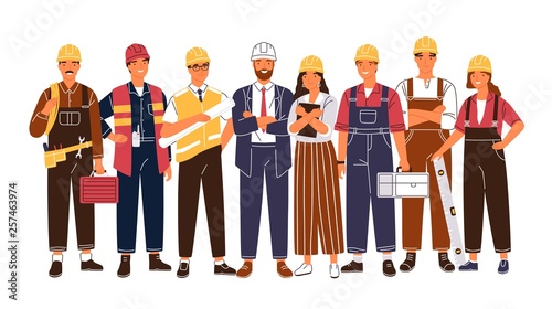 Group portrait of cute happy industry or construction workers, engineers standing together. Team of smiling male and female employees wearing hard hats and uniform. Flat cartoon vector illustration.