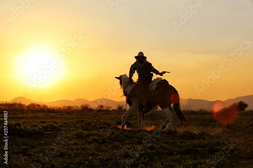 Fototapeta Naklejka Na Ścianę i Meble -  cowboy and horse  at first light,mountain, river and lifestyle with natural sunset light background