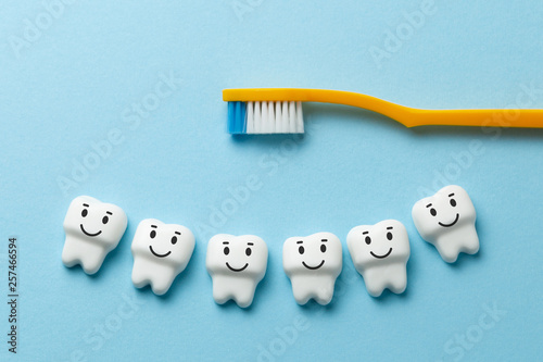 Healthy white teeth are smiling on blue background with toothbrush