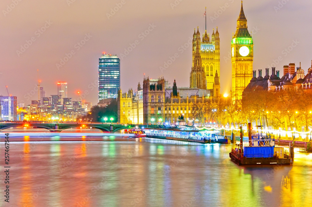 View of the Houses of Parliament along River Thames in London at night.