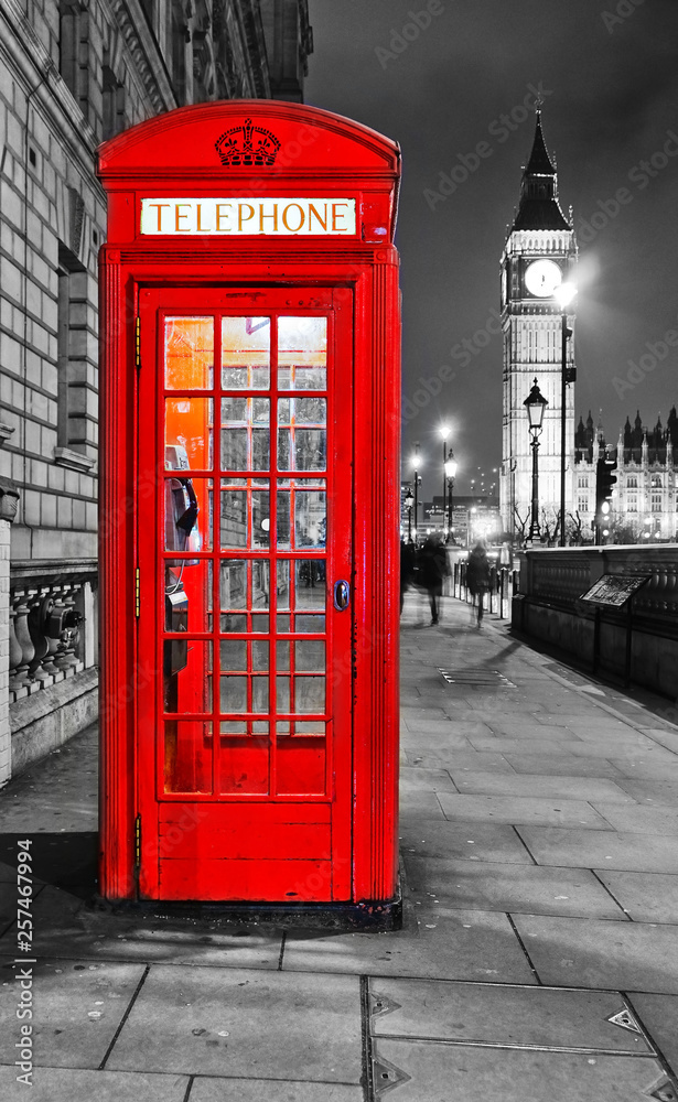 View of the Telephone Box and Houses of Parliament in London at night.