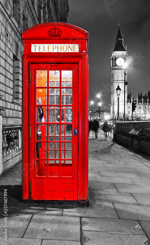 View of the Telephone Box and Houses of Parliament in London at night.