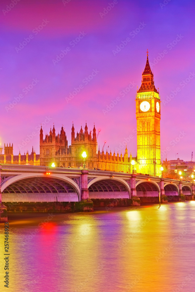 Fototapeta premium View of the Houses of Parliament and Westminster Bridge along River Thames in London at dusk.