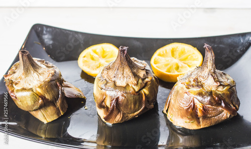 traditional cuisine: artichokes cooked in the oven with oil and lemon photo