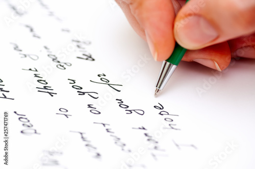 Woman hand with pen writing letter to the friend. photo