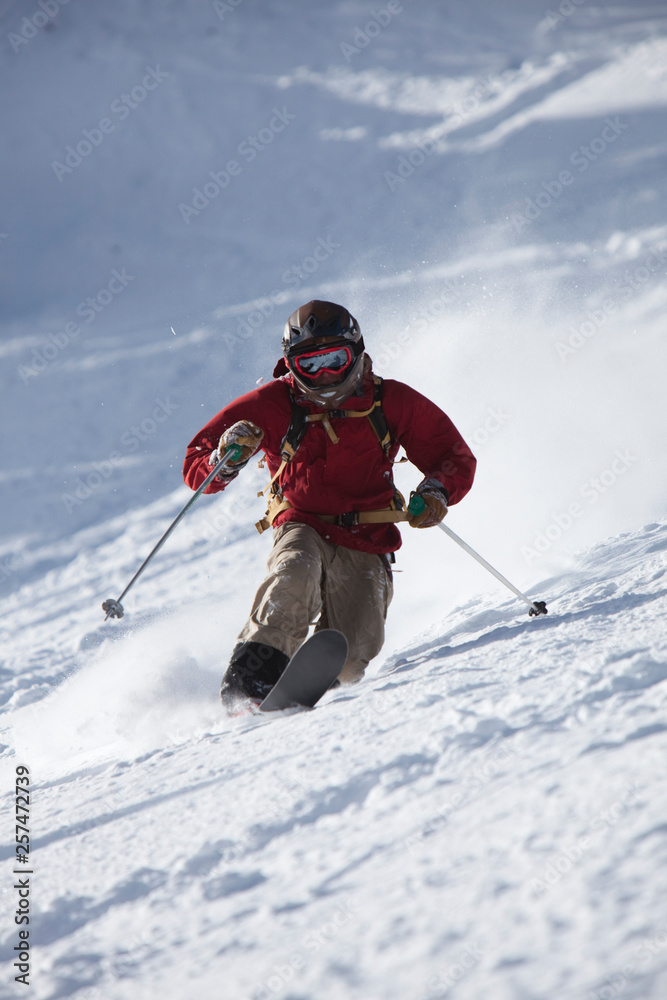 A male telemark skier rips turns in Bridger Bowl, Montana. A male telemark skier rips turns in Bridger Bowl, Montana.