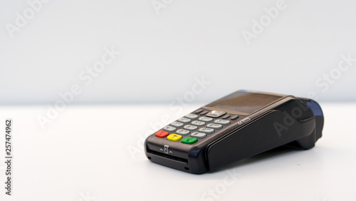 close up soft focus credit card reader  machine at white background table for  business financial about contactless payment concept