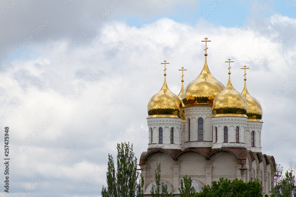 Domes of a religious building. Crosses on the domes of the church. Cathedral with silver domes against the sky