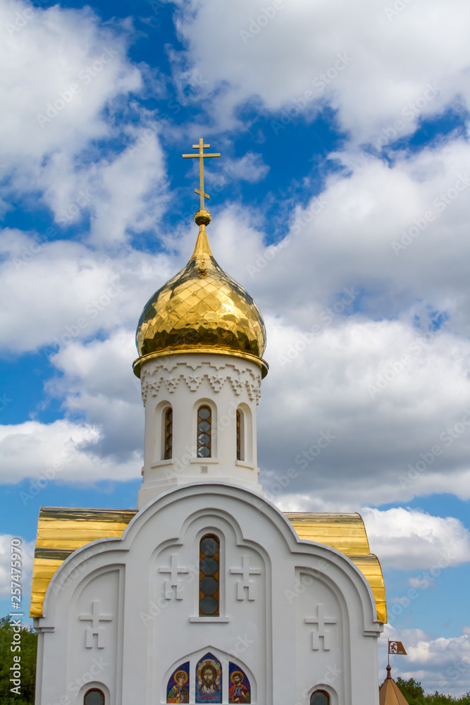 Domes of a religious building. Crosses on the domes of the church. Cathedral with silver domes against the sky