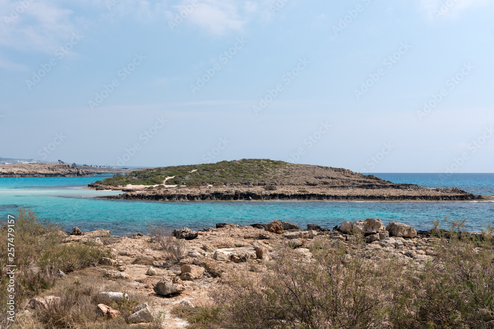 Crystal clear waters and sandstone rocks of the Mediterranean Sea, Cyprus. Tropical sea bay landscape, beach coastline