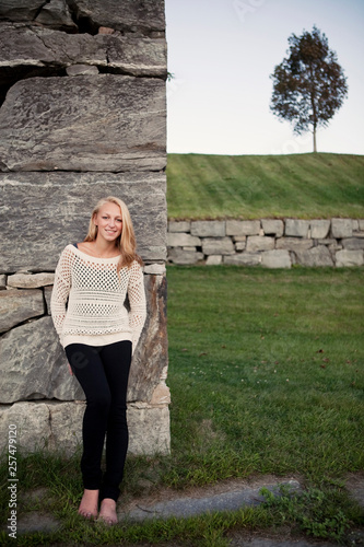 A young woman stands against a wall at the old armory in Augusta, Maine. photo