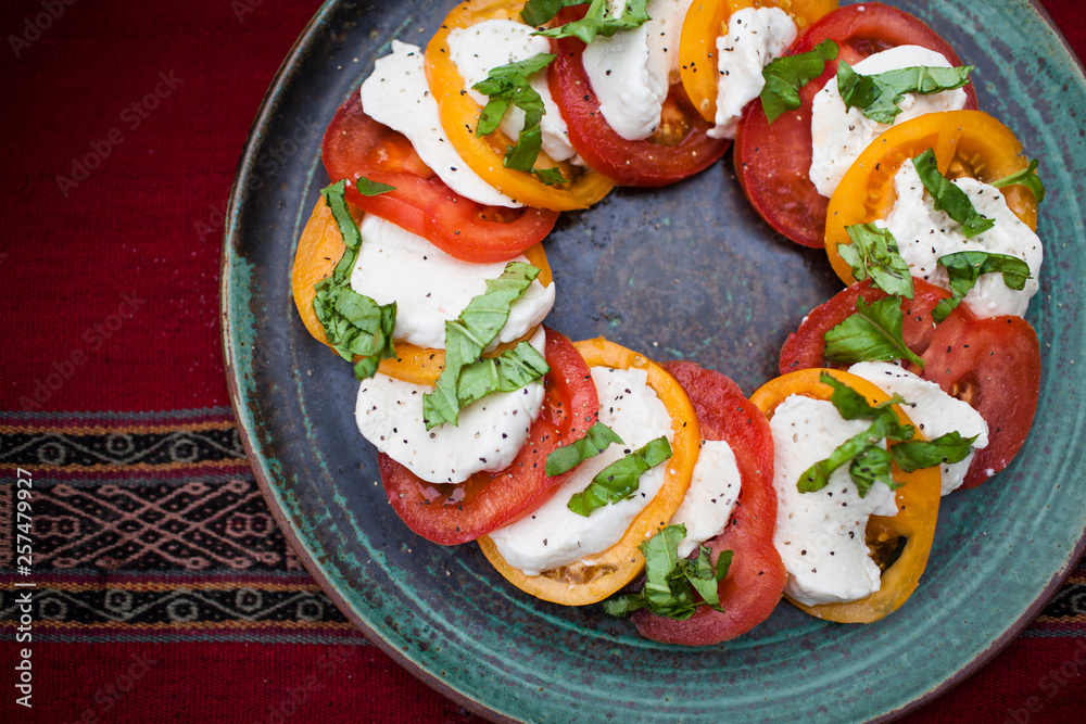 Overhead view of caprese salad served on a plate Overhead view of caprese salad served on a plate
