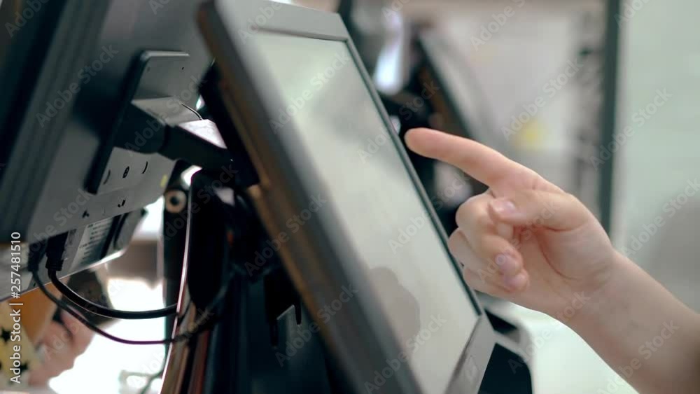 Cashiers are working, touching touch screen, choosing the right products. Cashiers are working, touching touch screen, choosing the right products.