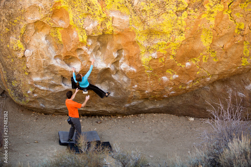 Mich Underhill spotting Sarah Felchlin while bouldering at the Buttermilk boulders just outside of Bishop California. photo