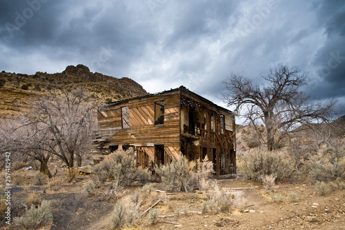 Old abandoned building in desert photo