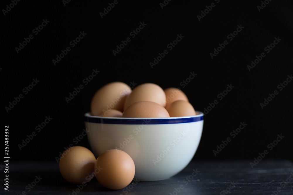 Eggs sit on a countertop in a bowl. Eggs sit on a countertop in a bowl.