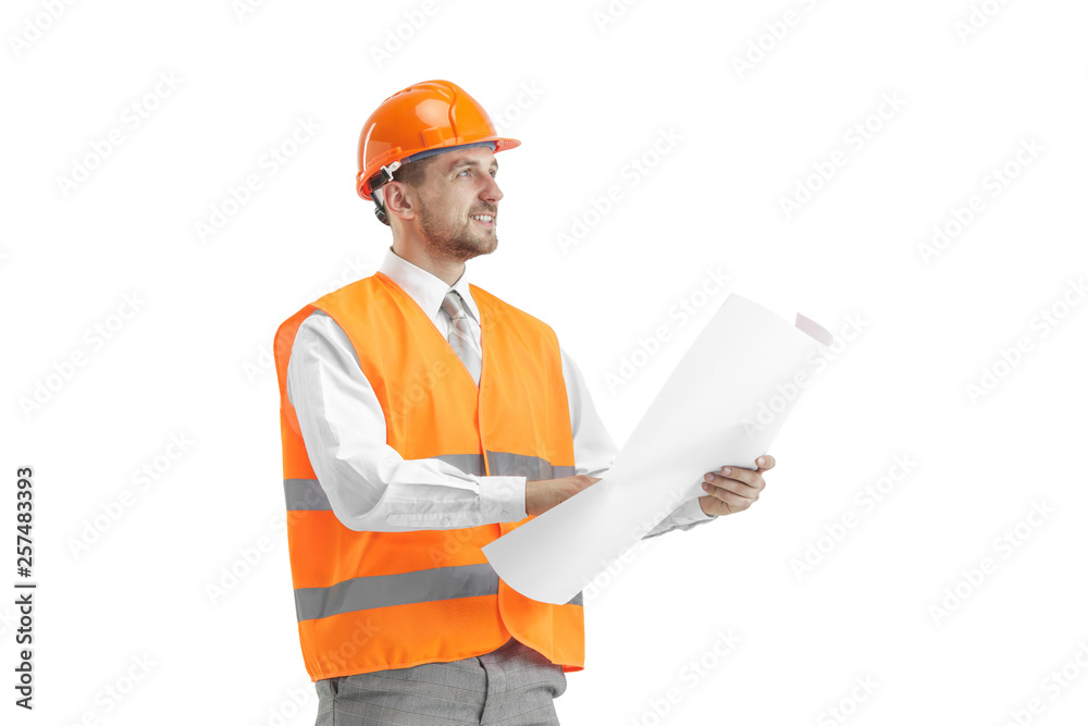 The builder in a construction vest and orange helmet standing on white studio background. Safety specialist, engineer, industry, architecture, manager, occupation, businessman, job concept The builder in a construction vest and orange helmet standing on white studio background. Safety specialist, engineer, industry, architecture, manager, occupation, businessman, job concept