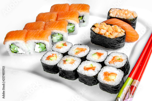 close up of sashimi sushi set, roll on white plate with chopsticks