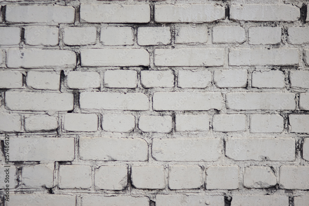 White abstract background in the form of a simple painted brick wall without inscriptions and drawings White abstract background in the form of a simple painted brick wall without inscriptions and drawings