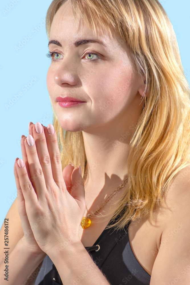 Closeup portrait Attractive young woman exercising and sitting in lotus yoga position, in bright room of sport hall Closeup portrait Attractive young woman exercising and sitting in lotus yoga position, in bright room of sport hall