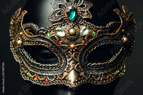 Black head of mannequin in creative metal mask with jewels