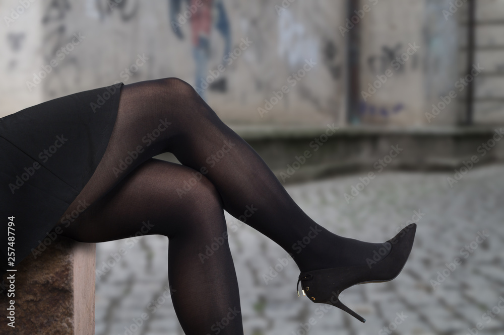 Sexy Female Legs Wearing High Heels And Black Tights Sitting On A Sexy Female Legs Wearing High Heels And Black Tights Sitting On A