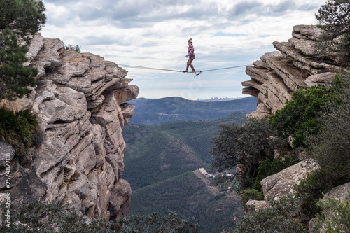 Man highlining between rocky cliffs, El Garbi, Valencia, Spain photo