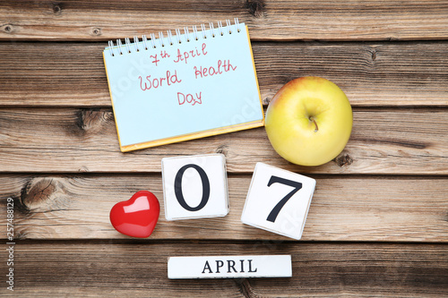 Fototapeta Naklejka Na Ścianę i Meble -  Text 7 April, World Health Day with apple and cube calendar on brown wooden table