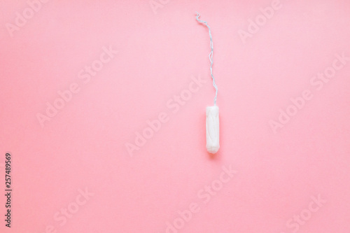 women intimate hygiene product - sanitary tampon on pink background.