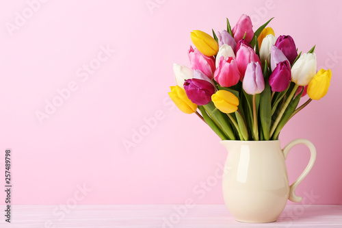 Fototapeta Naklejka Na Ścianę i Meble -  Bouquet of tulips in jug on wooden table