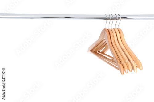 Wooden hangers hanging on white background