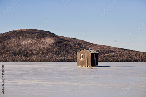 Ice fishing shack on frozen lake near Jackman, Maine, USA
