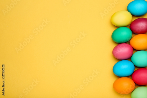 Colorful easter eggs on yellow background