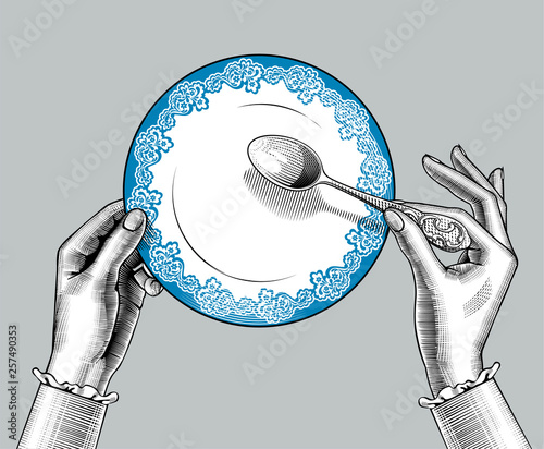 Female hands with plate and spoon