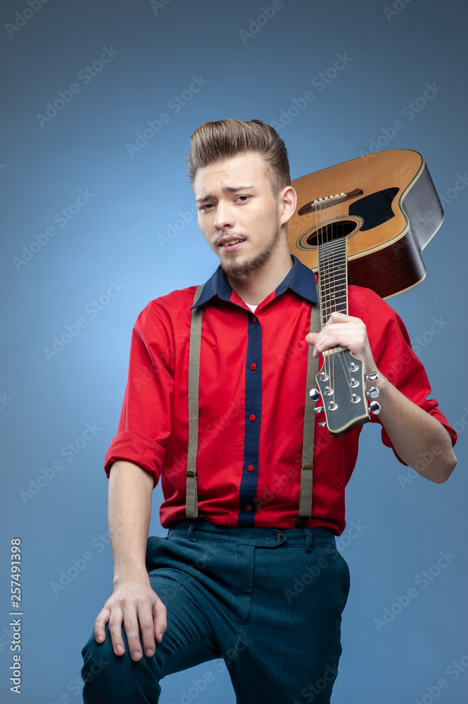 Young man dressed in rock'n'roll or rockabilly style. Photos | Adobe Stock