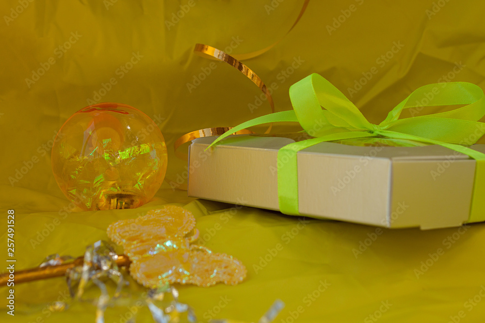 Silver gift box tied yellow ribbon bow on yellow background